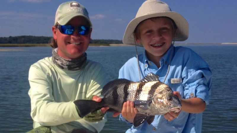 captain blair and young fisherman holding a fish caught on Hilton Head charter trip